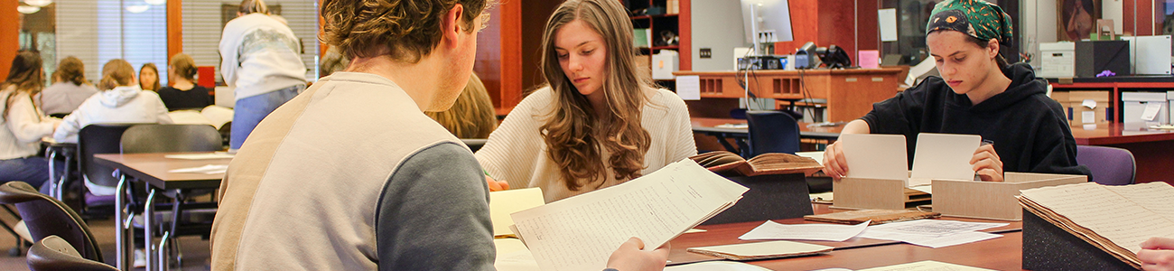 Students examine primary source materials in Special Collections