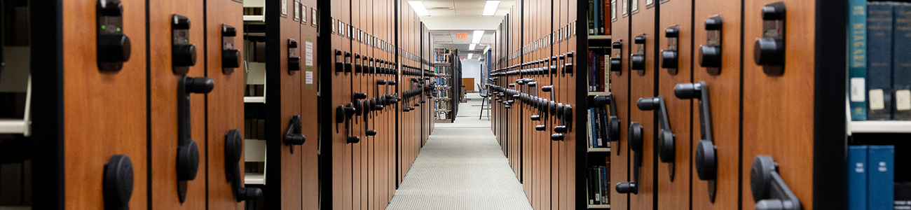 View down a corridor of library stacks