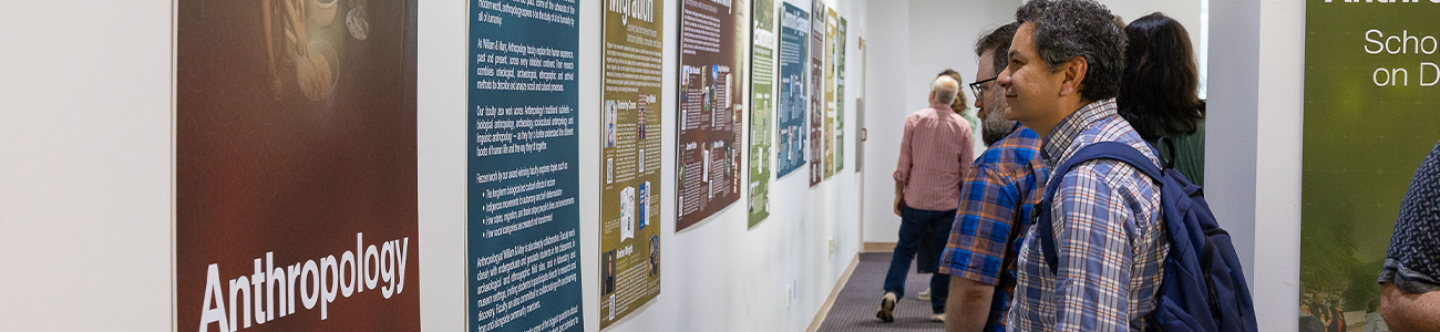 People gathered in the lobby to view the Anthropology Scholarship on Display exhibit