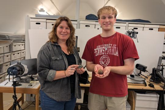 Andrew Francois and curator at Jamestown Rediscovery holding 3D models of artifacts.