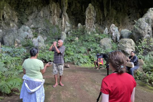 Image of an anthropologist filming an interview during field research