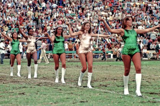  Cheer squad performing on the field of a football game