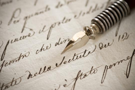 Handwritten letter with vintage fountain pen on top