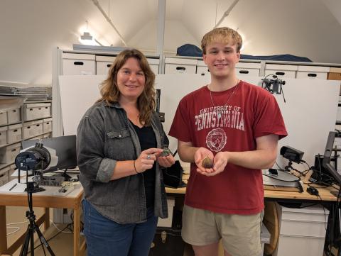 Andrew Francois and curator at Jamestown Rediscovery holding 3D models of artifacts.