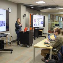 Student gives a presentation to other students in the Cox Classroom