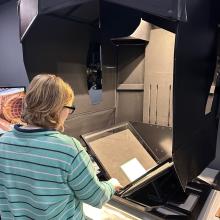 A student scanning the Monitor Journal