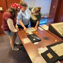 Students view historic artifacts, including a 19th-century amputation saw.