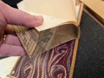 corner of a fore edge painting revealed by fanning the book pages