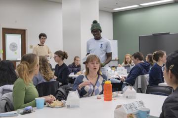 Students talking during dinner time at Honors Thesis Retreat