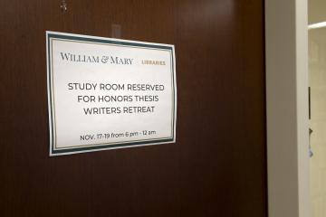 A sign on a study room reserving it for honors thesis retreat