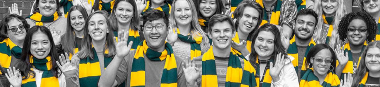 Black and white photo of library student employees wearing W&M scarves in green and yellow