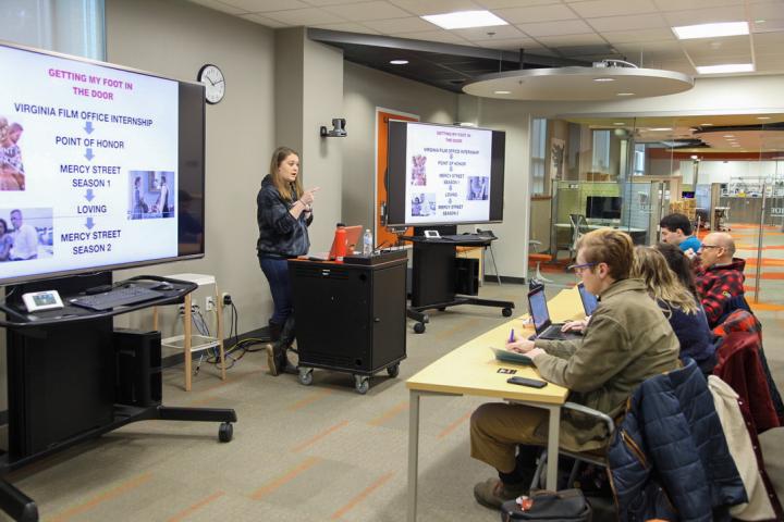 Student gives a presentation to other students in the Cox Classroom