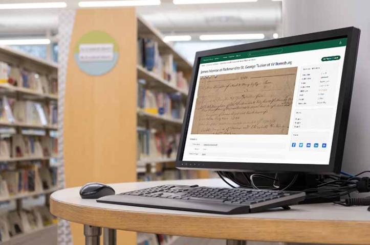 Computer workstation in front of shelves of books
