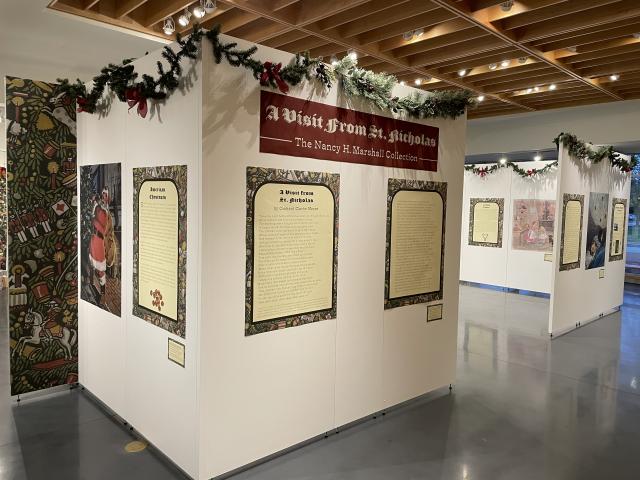 Exhibit panels with illustrations and text related to holiday food culture in 'Twas the Night Before Christmas