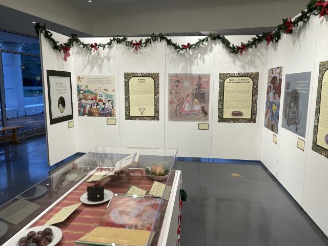 Exhibit panels with illustrations and text related to holiday food culture in 'Twas the Night Before Christmas