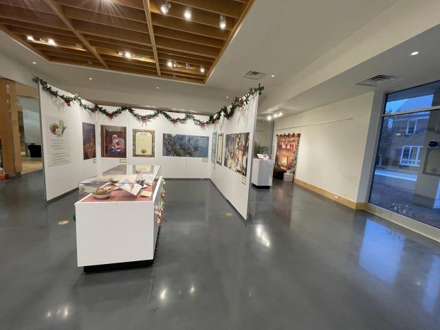 Exhibit panels and case with illustrations and text related to holiday food culture in 'Twas the Night Before Christmas