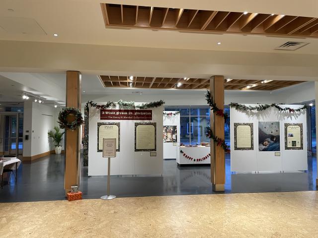 Exhibit with illustrations and text related to holiday food culture in 'Twas the Night Before Christmas