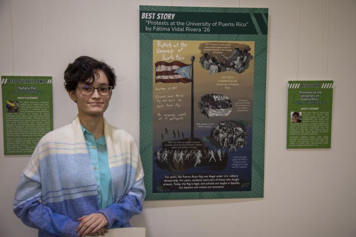 Fátima stands in front of their winning submission on display