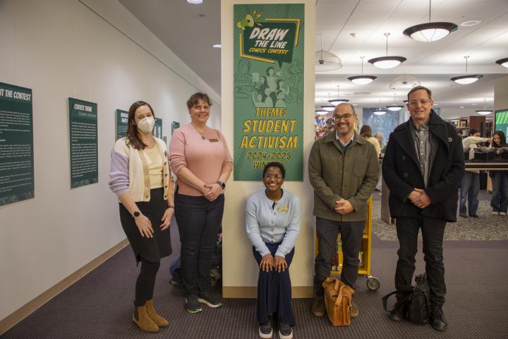 the judges of the contest pose for a photo in front of the exhibit