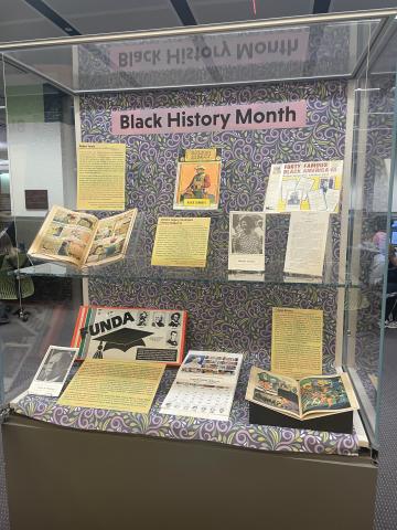 Black History Month exhibit featuring educational games, comics, and ephemera