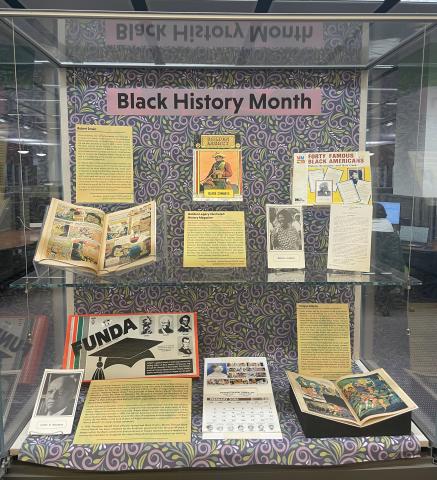 Black History Month exhibit featuring educational games, comics, and ephemera