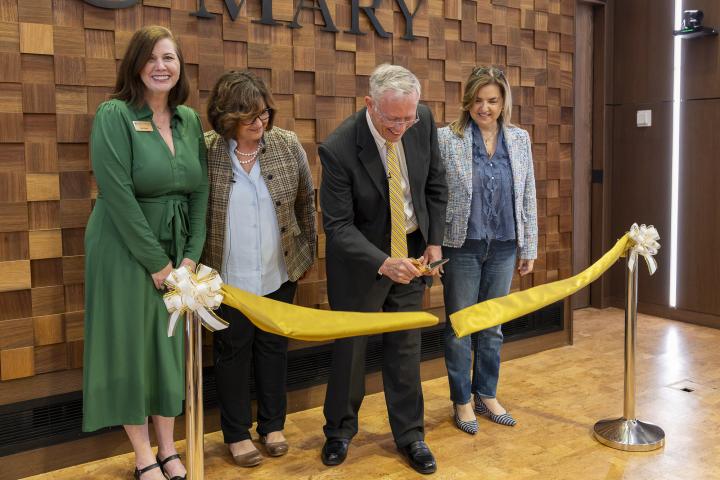 Earle MacKenzie cutting a ribbon