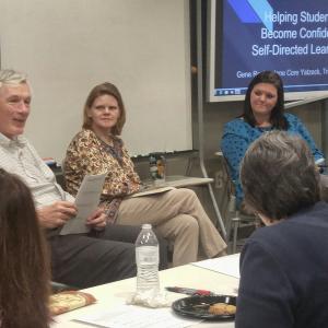 A three-person panel takes questions from the audience in the Ford Classroom