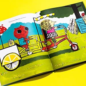 Open children's book showing a two-seater bicycle