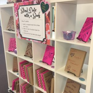 Books wrapped in paper adorn the Blind Date with a Book display