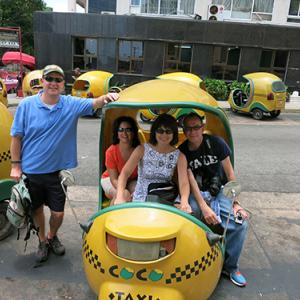 Swem library staff in a small yellow cab in Cuba