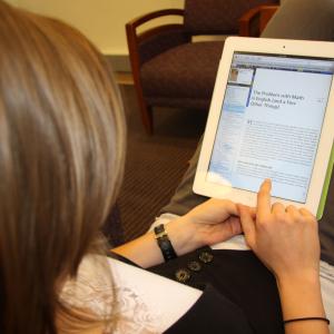 Person reading an e-book on a handheld device
