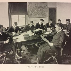 The Flat Hat staff at work seated together around a long table
