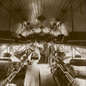 Nurse standing next to a medical cot