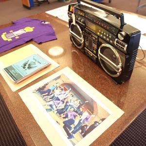 Hip Hop open house featuring photographs, t-shirts, and a boom box