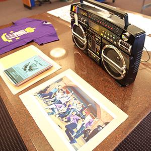Hip Hop open house featuring photographs, t-shirts, and a boom box
