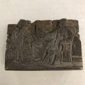 Woodcut of a boy and man with book