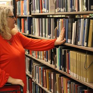 Person browsing a shelf of books