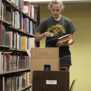 Student employee shelving books