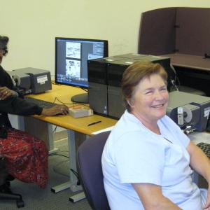 Two Swem staff members test out new microfilm scanners