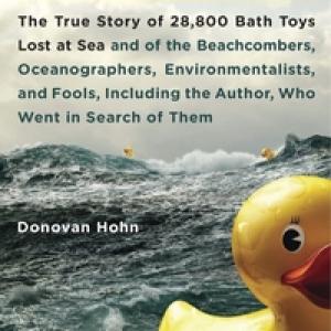 Ocean waves in the background and a yellow rubber duck in front