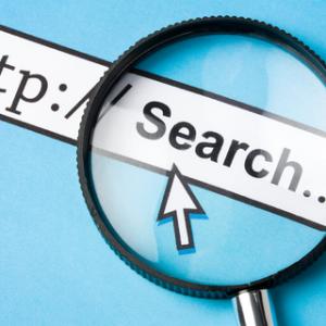 Magnifying glass on top of the word Search