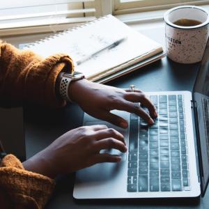 Closeup of hands typing on a laptop