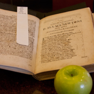 Newton's Principia posed next to an apple