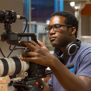 Robert Boyd shooting video on a camera from the Reeder Media Center