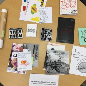 Table covered in new zines acquired by the library