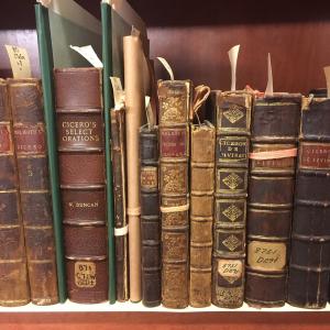 Shelf of rare books with leather-bound covers