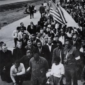Group of protestors with a US flag