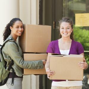 Two students holding cardboard boxes