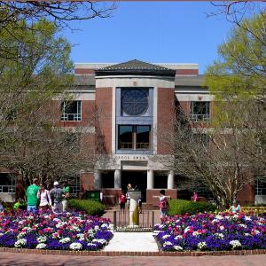 Swem Library in spring with purple and white flowers