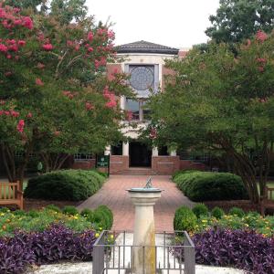 Front entrance of Swem Library with the sun dial in the foreground